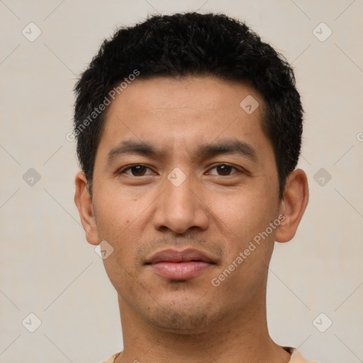 Joyful latino young-adult male with short  black hair and brown eyes