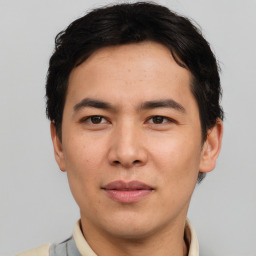 Joyful asian young-adult male with short  brown hair and brown eyes