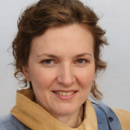 Joyful white adult female with medium  brown hair and blue eyes