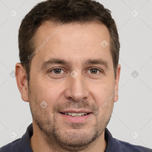 Joyful white adult male with short  brown hair and brown eyes