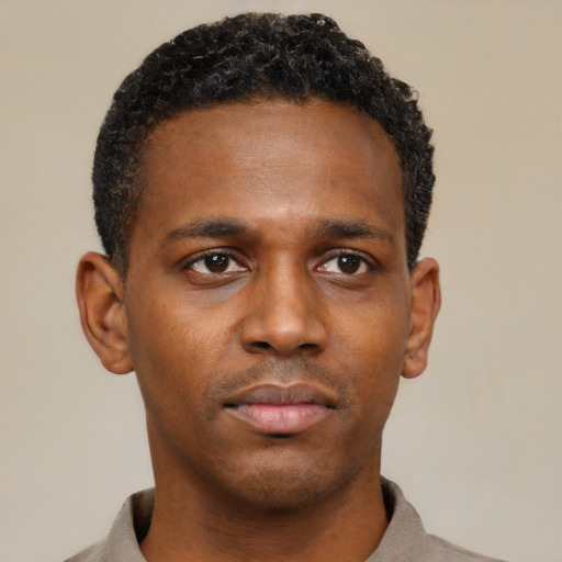 Neutral black young-adult male with short  black hair and brown eyes