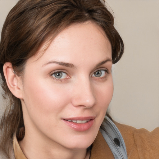 Joyful white young-adult female with medium  brown hair and blue eyes