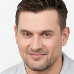 Joyful white adult male with short  brown hair and brown eyes