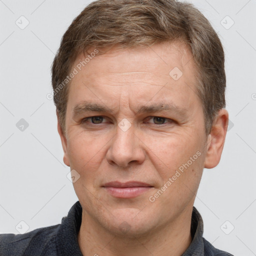 Joyful white adult male with short  brown hair and grey eyes