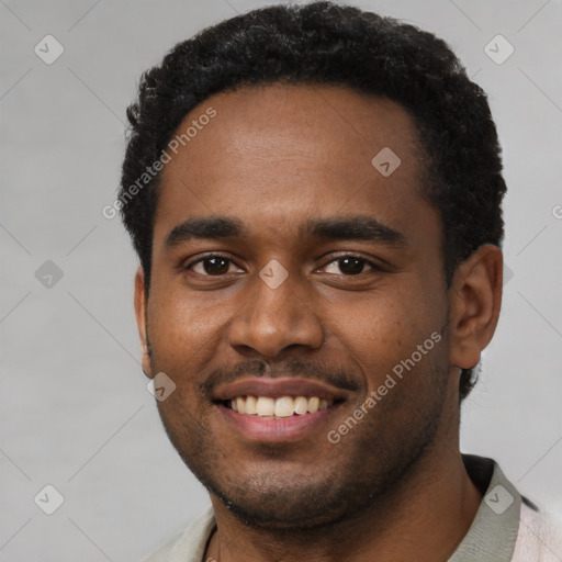 Joyful black young-adult male with short  brown hair and brown eyes