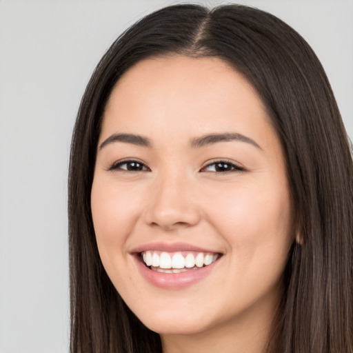 Joyful white young-adult female with long  black hair and brown eyes