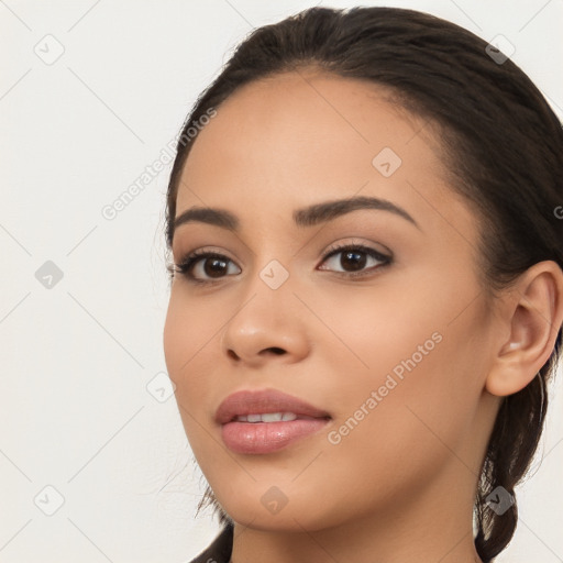 Joyful latino young-adult female with long  brown hair and brown eyes