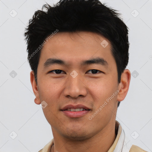 Joyful asian young-adult male with short  black hair and brown eyes