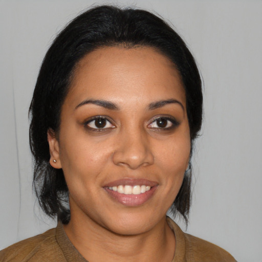 Joyful black young-adult female with medium  brown hair and brown eyes