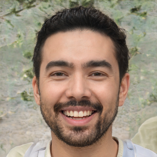 Joyful white young-adult male with short  black hair and brown eyes