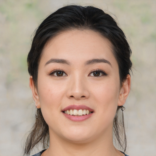 Joyful asian young-adult female with medium  brown hair and brown eyes