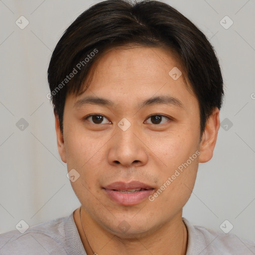 Joyful asian young-adult male with short  brown hair and brown eyes