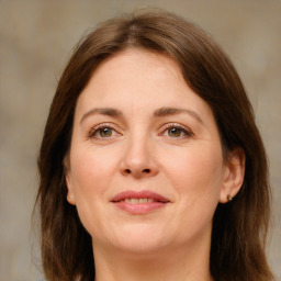 Joyful white adult female with medium  brown hair and green eyes