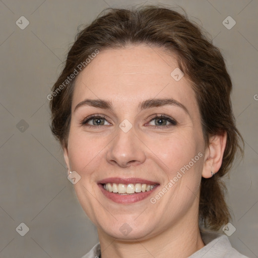 Joyful white adult female with medium  brown hair and grey eyes