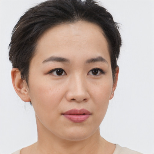 Joyful asian young-adult female with short  brown hair and brown eyes