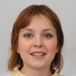 Joyful white young-adult female with medium  brown hair and blue eyes