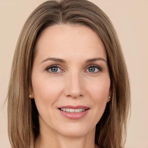 Joyful white young-adult female with long  brown hair and green eyes