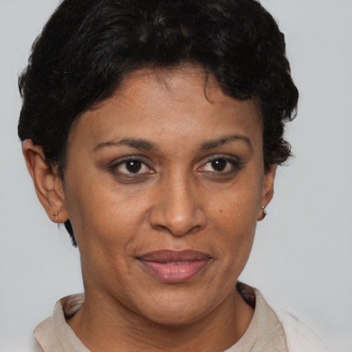 Joyful black adult female with short  brown hair and brown eyes
