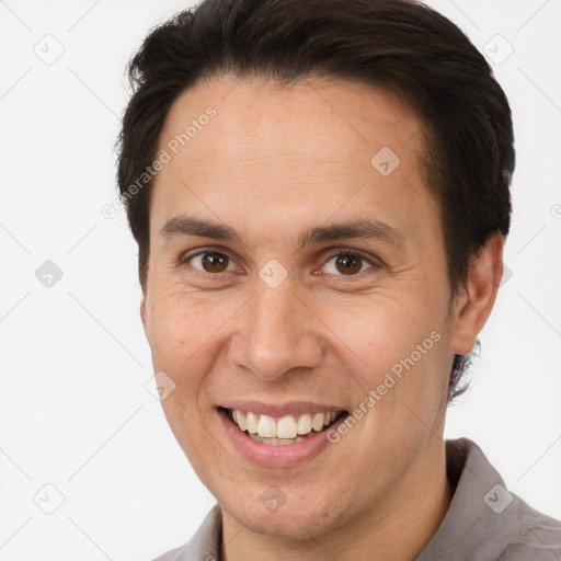 Joyful white adult male with short  brown hair and brown eyes