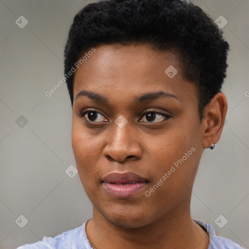 Joyful black young-adult female with short  black hair and brown eyes