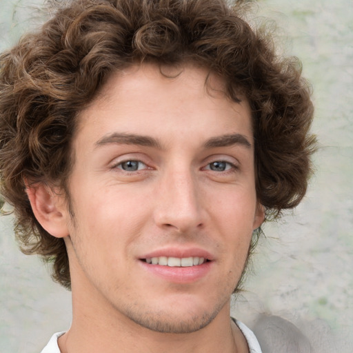 Joyful white young-adult male with medium  brown hair and green eyes