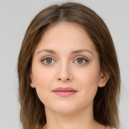 Joyful white young-adult female with long  brown hair and green eyes