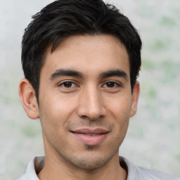 Joyful latino young-adult male with short  black hair and brown eyes