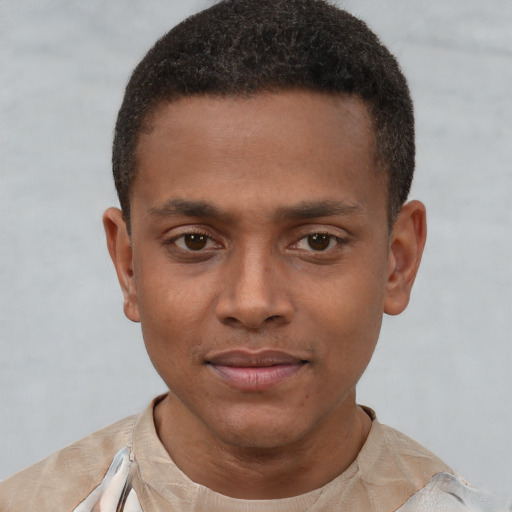 Joyful latino young-adult male with short  brown hair and brown eyes