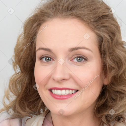 Joyful white young-adult female with long  brown hair and blue eyes