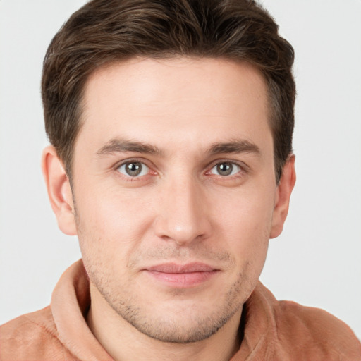 Joyful white young-adult male with short  brown hair and brown eyes