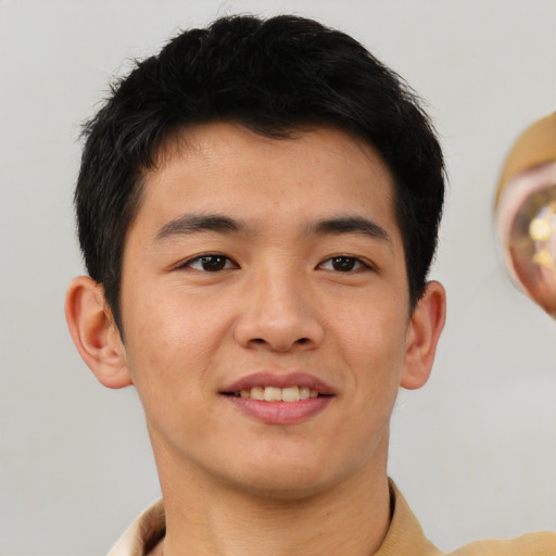 Joyful asian young-adult male with short  brown hair and brown eyes
