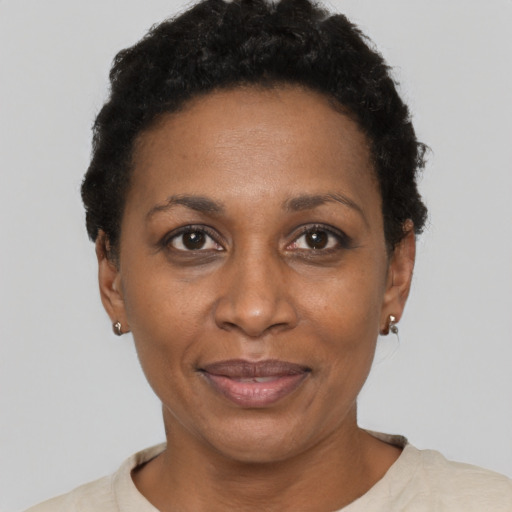 Joyful black adult female with short  black hair and brown eyes