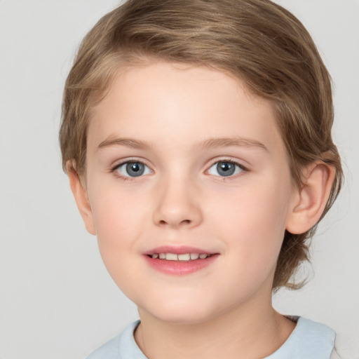 Joyful white child female with short  brown hair and grey eyes