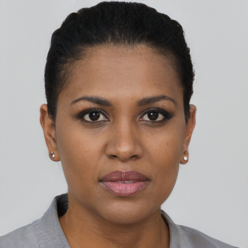 Joyful black young-adult female with short  brown hair and brown eyes