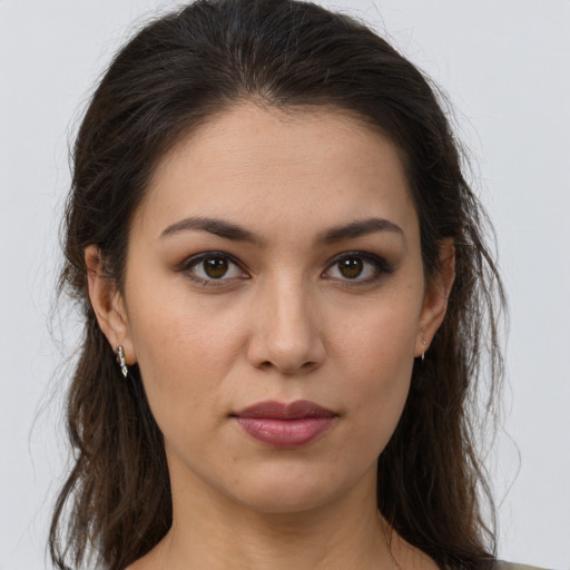 Joyful white young-adult female with long  brown hair and brown eyes