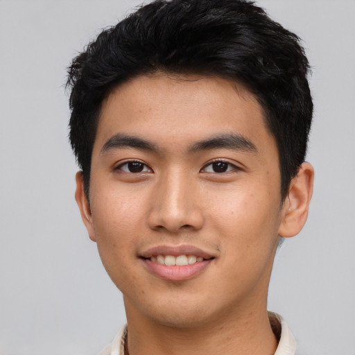 Joyful asian young-adult male with short  black hair and brown eyes