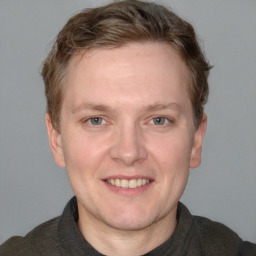 Joyful white adult male with short  brown hair and grey eyes