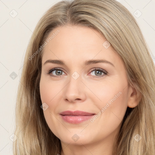 Joyful white young-adult female with long  brown hair and brown eyes