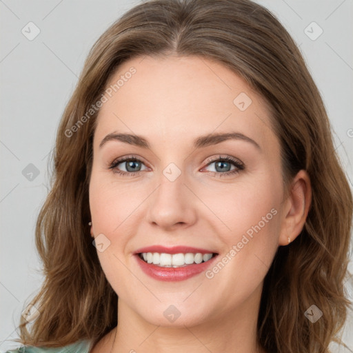 Joyful white young-adult female with long  brown hair and green eyes