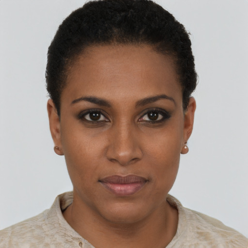 Joyful black young-adult female with short  black hair and brown eyes