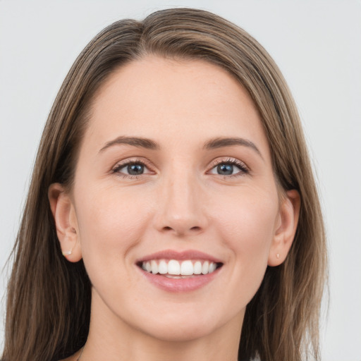 Joyful white young-adult female with long  brown hair and grey eyes