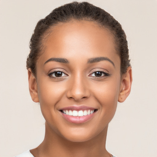 Joyful latino young-adult female with short  brown hair and brown eyes