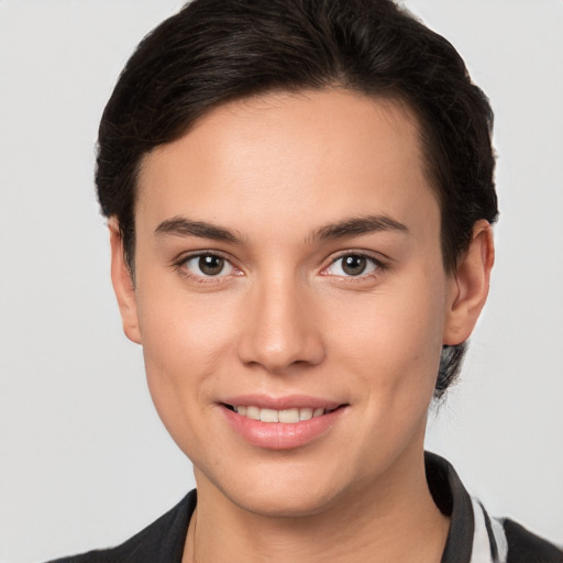 Joyful white young-adult female with short  brown hair and brown eyes