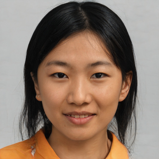 Joyful asian young-adult female with medium  black hair and brown eyes