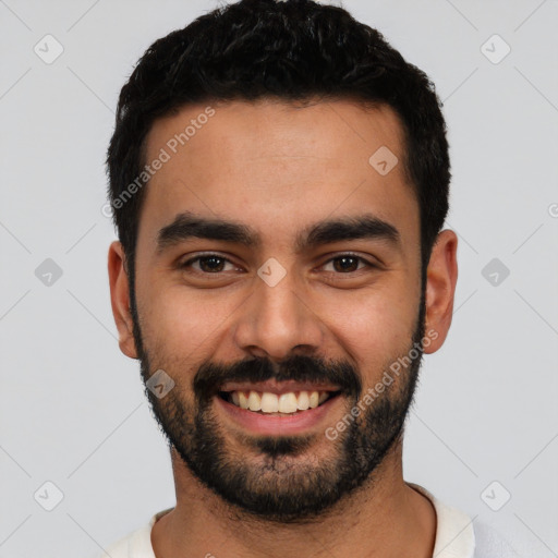 Joyful latino young-adult male with short  black hair and brown eyes