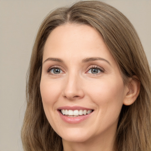 Joyful white young-adult female with long  brown hair and green eyes