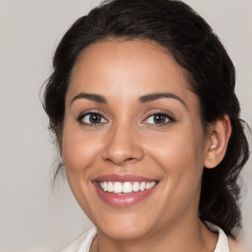 Joyful white young-adult female with medium  brown hair and brown eyes