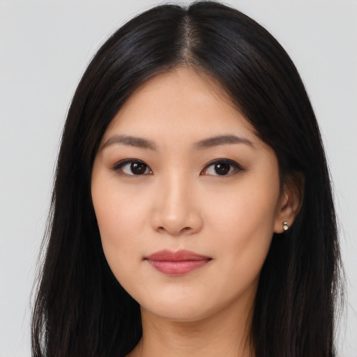 Joyful asian young-adult female with long  black hair and brown eyes