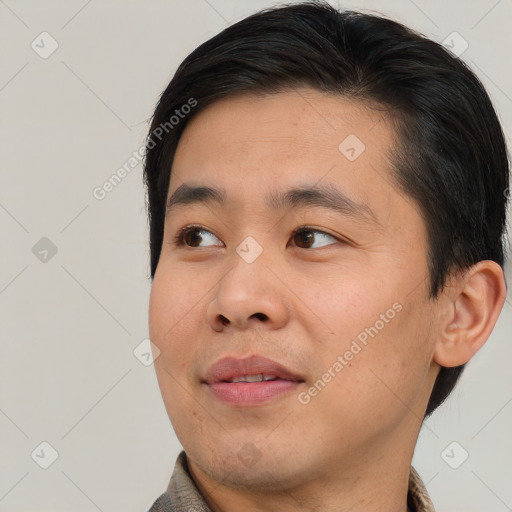 Joyful asian young-adult male with short  brown hair and brown eyes