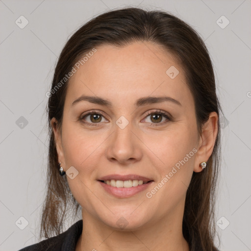 Joyful white young-adult female with long  brown hair and brown eyes